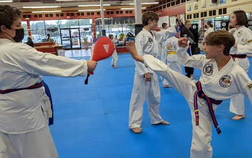 a group of people in karate uniforms