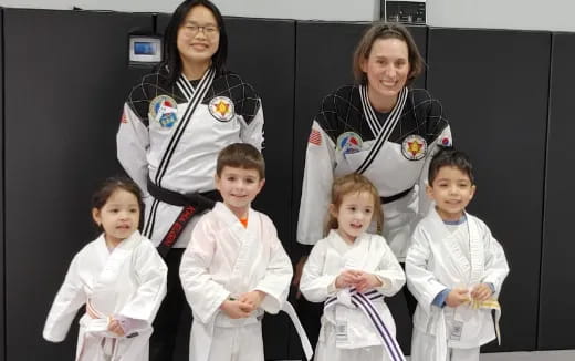 a group of people in karate uniforms