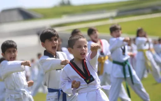 a group of boys in white uniforms