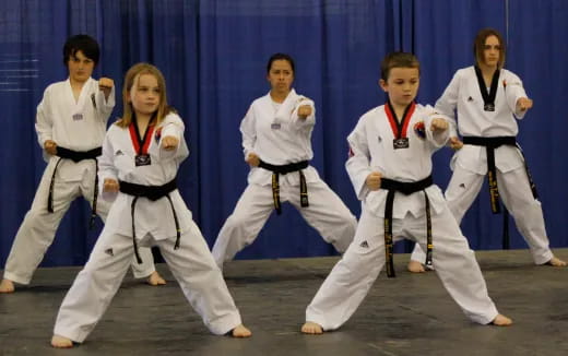 a group of people in karate uniforms