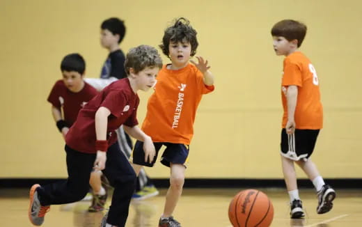 a group of kids playing basketball
