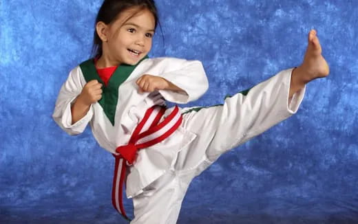 a young girl in a karate uniform