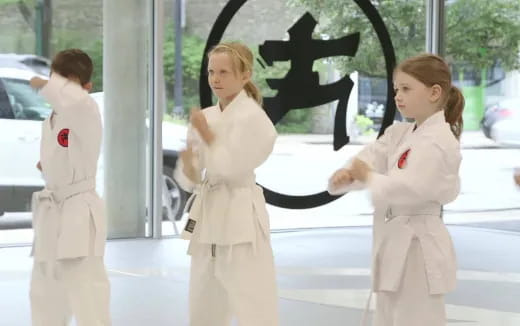 a group of women in white outfits