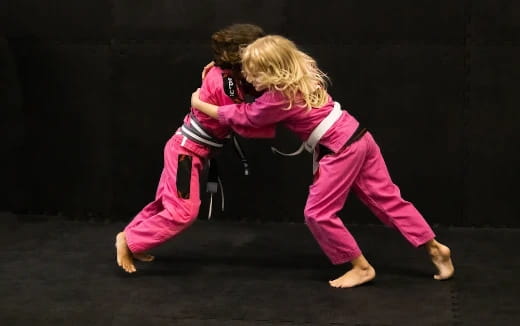 a man and woman in pink suits