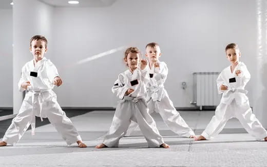 a group of people in karate uniforms