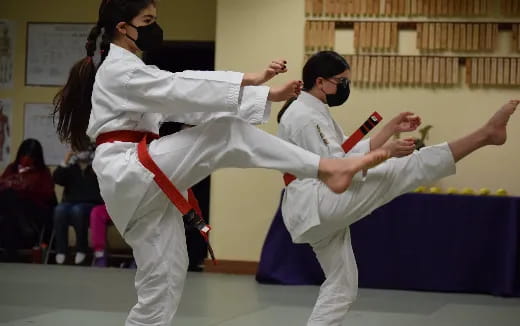 a man and woman in karate uniforms
