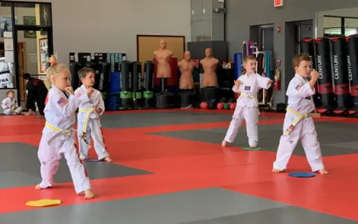 a group of children in karate uniforms
