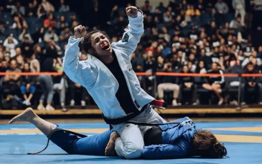 a man and a woman doing a handstand on a mat