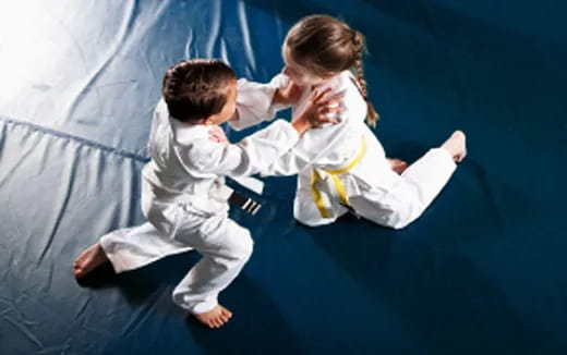 a man and a woman in karate uniforms