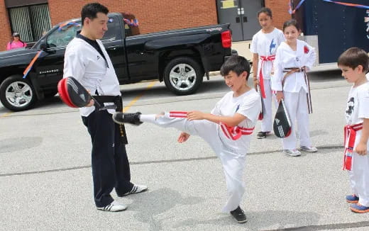 a group of people in white karate uniforms