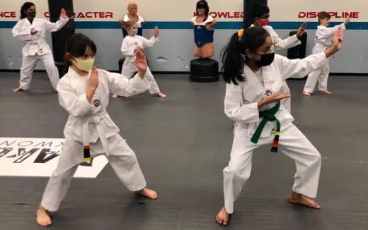 a group of people in white karate uniforms