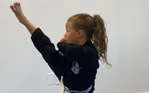a young girl with her hands up