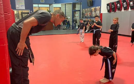 a person and a boy in a gym