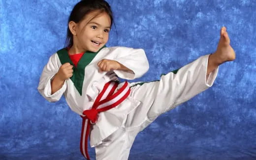 a girl in a karate uniform