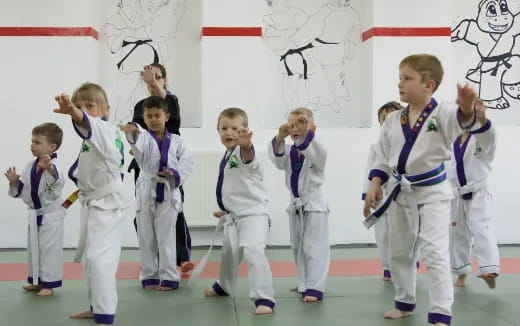 a group of children in karate uniforms