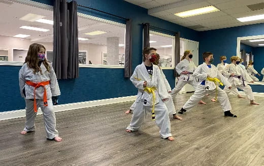 a group of people in karate uniforms