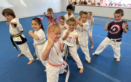 a group of children in karate uniforms
