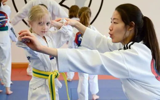 a group of girls in karate uniforms