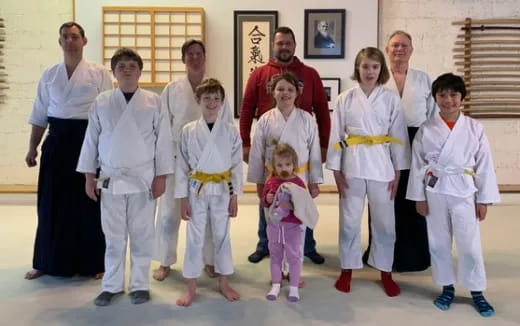 a group of people in white karate uniforms