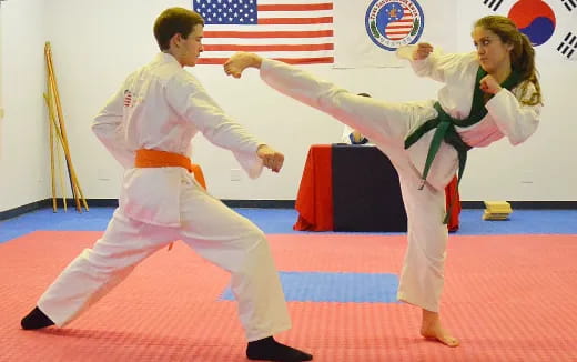 a man and woman in karate uniforms