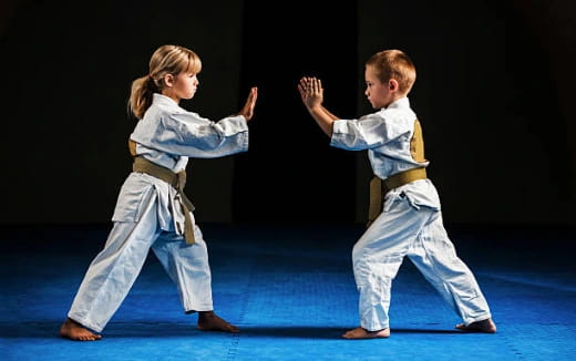 a boy and girl in karate uniforms