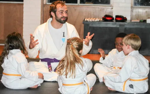 a person standing in front of a group of children
