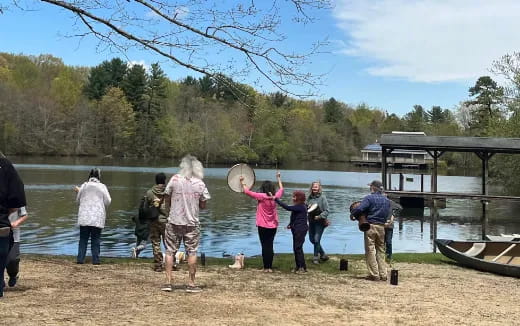 a group of people standing on a beach