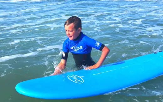 a boy on a surfboard