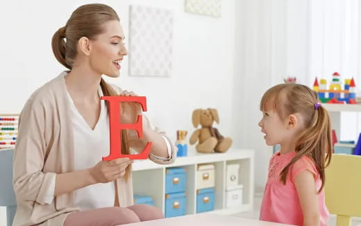 a woman and a girl holding a gift box