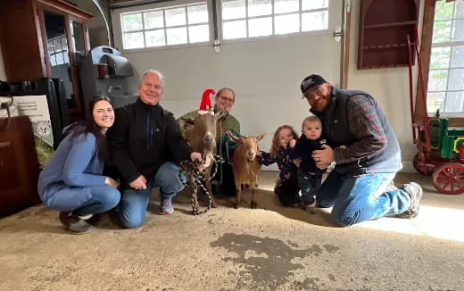 a group of people posing with donkeys