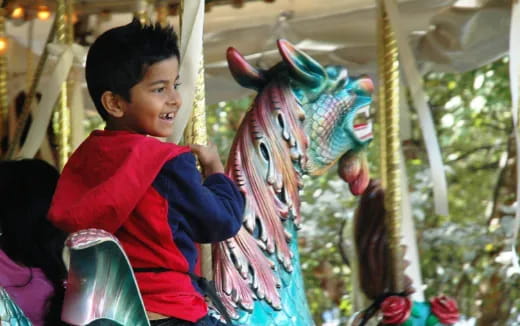 a boy riding a horse