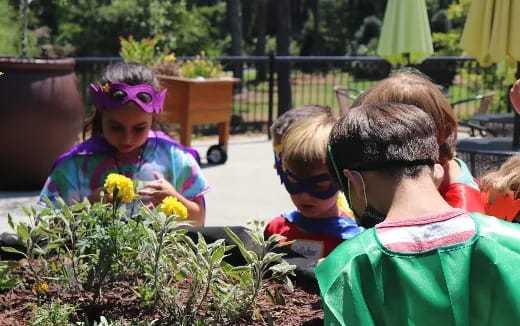 a group of children looking at flowers