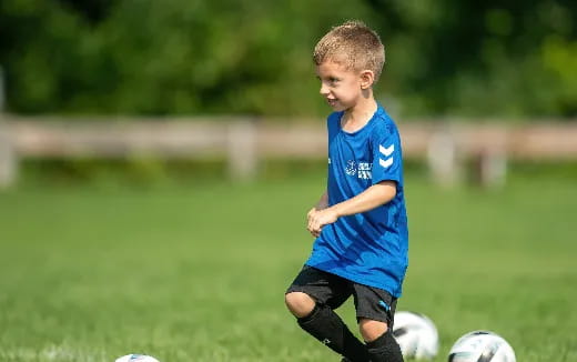 a young boy playing football