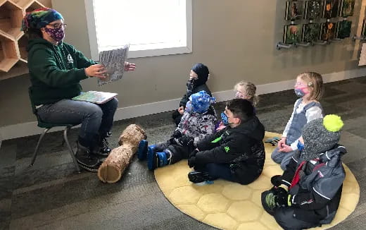 a group of people sitting on the floor with stuffed animals