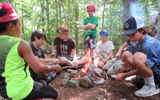a group of people around a campfire