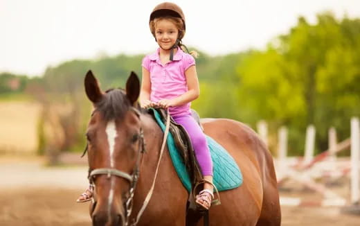 a girl riding a horse