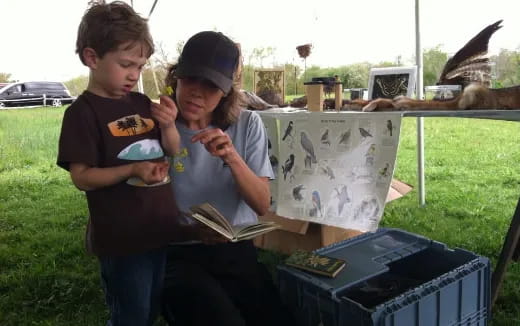 a group of kids looking at a book