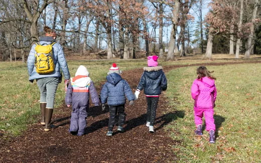 a group of people walking in a field