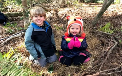 two children sitting in the grass