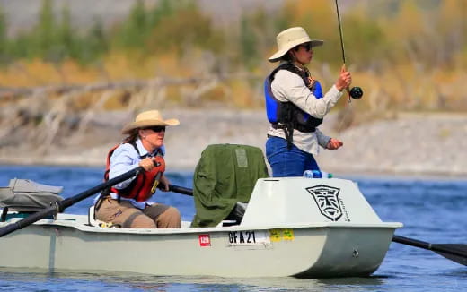 a couple of people rowing a boat