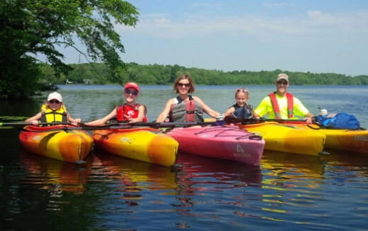 a group of people in canoes