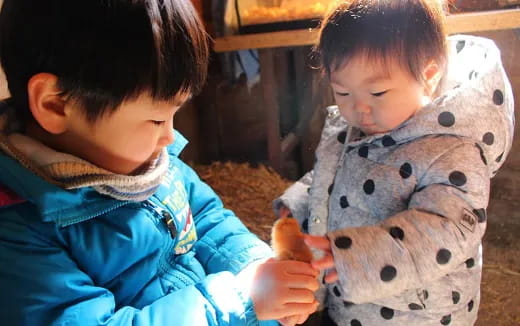 a couple of kids playing with a stuffed animal