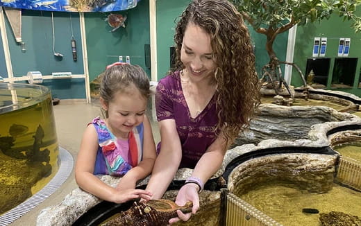a person and a child in a water fountain