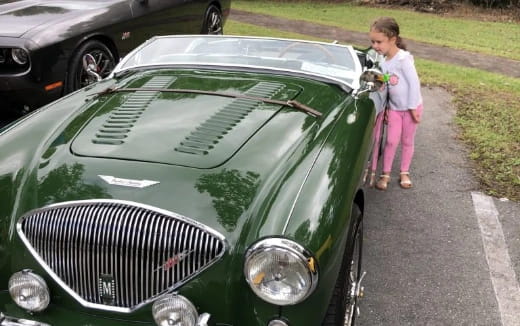 a person standing next to a car
