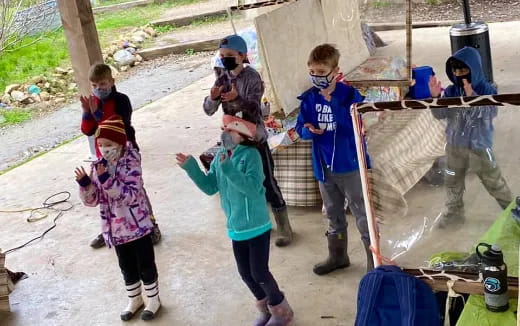 a group of children holding tools