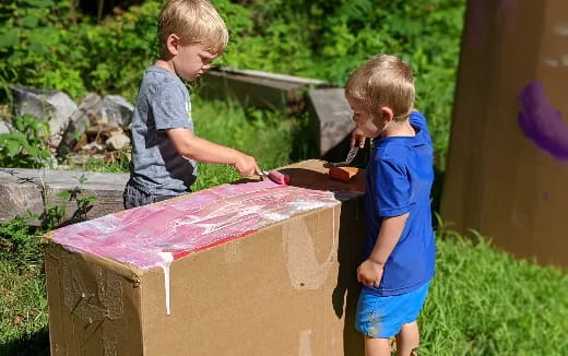 a couple of boys building a house