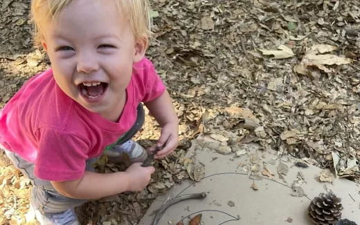 a child playing with a turtle
