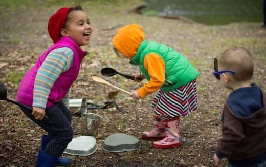 children playing outside with shovels