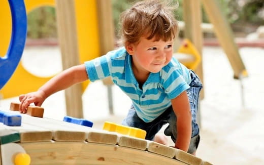 a boy playing with a toy
