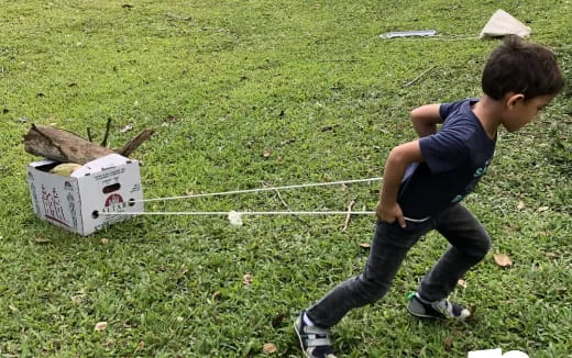 a boy playing with a box